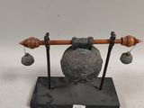 an image of a sculpture of a bell and bells on a stand