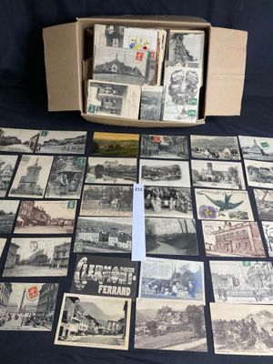 an old photo of a bunch of old postcards in a box