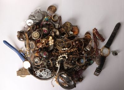 a pile of assorted jewelry on a white surface