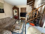 a living room with a leopard print couch and a coffee table