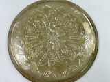 a glass plate with a design on it on a table