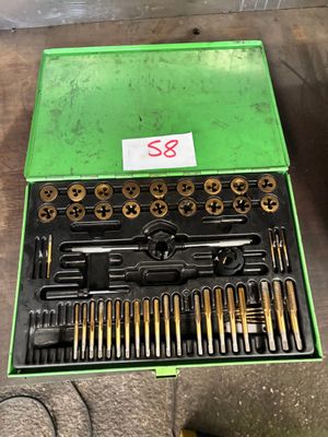 a green box with a bunch of tools in it