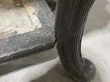 a black table with a marble top and a metal base