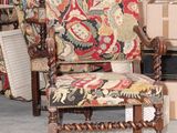 a chair that is sitting in front of a pile of boxes