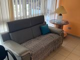 a couch and a table in a room with orange walls