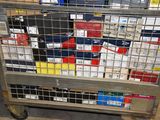 a metal cart with many boxes on it in a warehouse