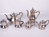 silver plated tea and coffee set on a white surface