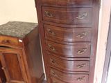 a small chest of drawers next to a table with a marble top