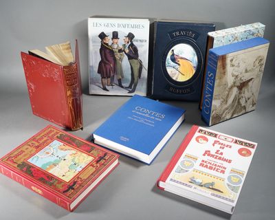 several books are lined up on a table with a gray background