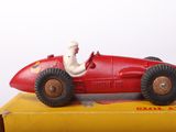 a red toy car with a man in the driver ' s seat