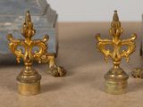 two gold colored candlesticks sitting on a table