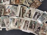 a lot of old photos of people on the table