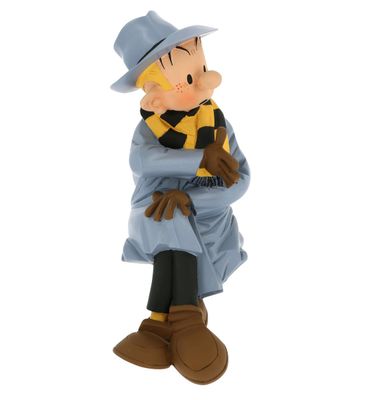 figurine of a man in a blue coat and hat sitting on a chair