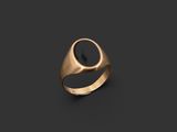 a gold ring with a black stone in the center