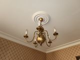 a chandelier in the corner of a room with a mirror on the wall