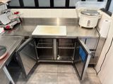 a kitchen with stainless steel counter tops and appliances