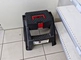 a small step stool in the middle of a tiled floor