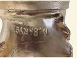 a close up of a silver vase with writing on it