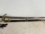 a sword with a wooden handle sitting on top of a floor