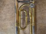 an old brass instrument sitting on top of a wooden floor