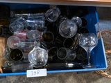 many empty wine glasses and bottles in a blue box