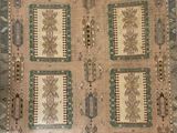 beige and blue area rug with a design of palm trees and palm trees on it