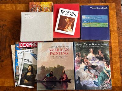 several books are sitting on a table next to each other