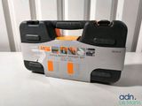 a black and orange tool case sitting on a white table