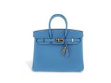 a blue leather handbag on a white background