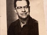 a black and white photo of a man with glasses