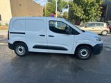 a white van parked in a parking lot next to a building
