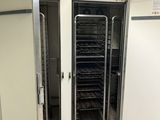 two ovens that are in a room with tile flooring