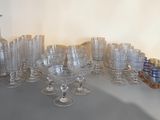 a lot of glasses and vases on the table