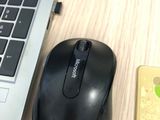 a computer mouse and a cell phone on a desk