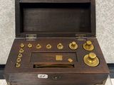 a small wooden box with brass knobs on it