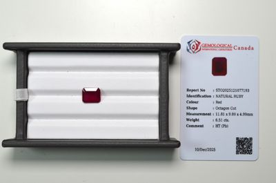 a red diamond in a black box next to a white card