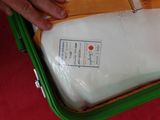 a person holding a piece of paper in a suitcase