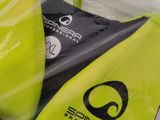 a yellow surfboard in a plastic bag on a table