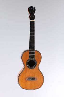 an image of a guitar hanging from a string on a wall