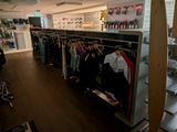 a room with a lot of clothes hanging on a rack