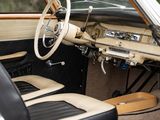 a white car with black leather seats and a steering wheel