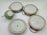 four pieces of chinese teapots and a teapot on a white surface