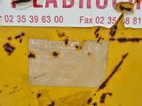 a sticker on the side of a yellow dumpster