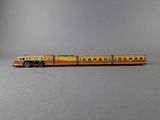 a toy train that is sitting on a gray surface