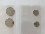 three coins in a clear plastic bag on a white surface