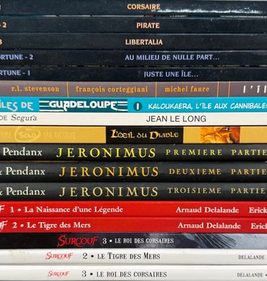 many books stacked on top of each other on a table