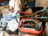 a man standing next to a pile of skis and ski poles