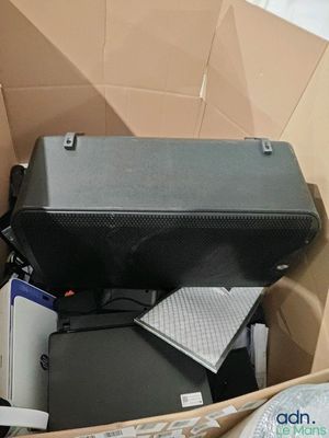 a suitcase and other items in a box on the floor
