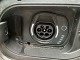 a close up of a car ' s charging station with a car plugged in