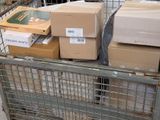 many boxes in a metal cart on the street